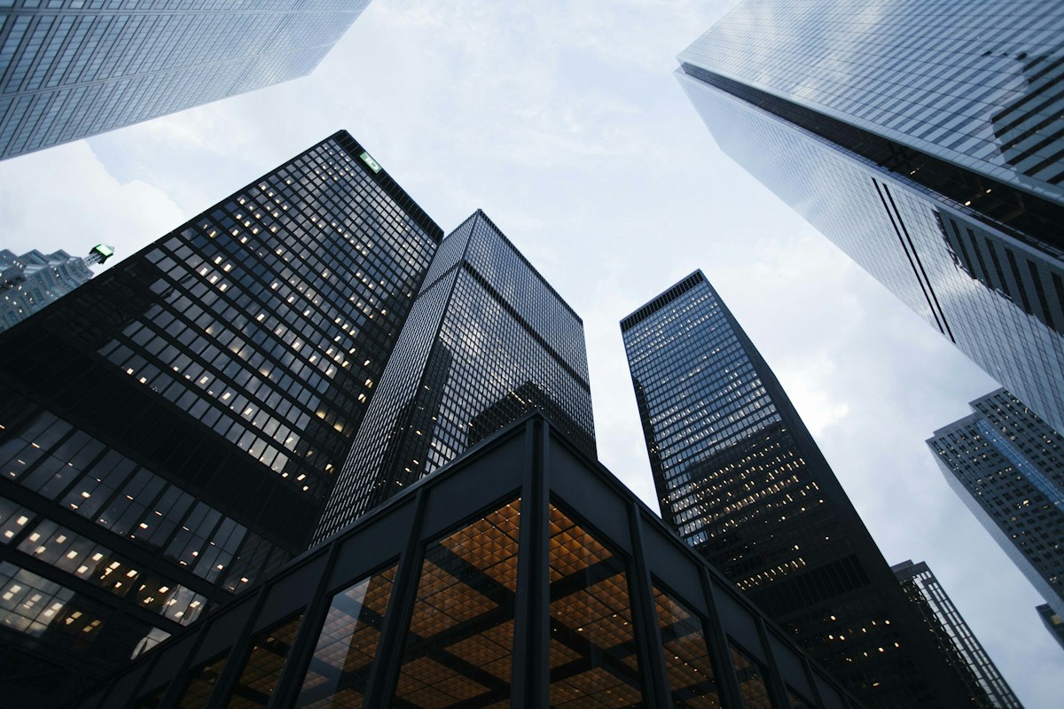 Modern glass architecture with geometric lines meeting the sky